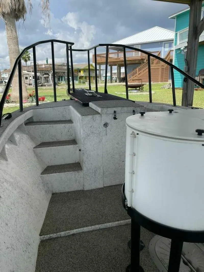 Slide: The Image of 1997 Custom 31 Center Console boat interior with steps and railing. - 14