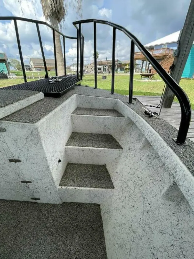 Slide: The Image of Steps and railing on a 1997 Custom 31 Center Console boat. - 18