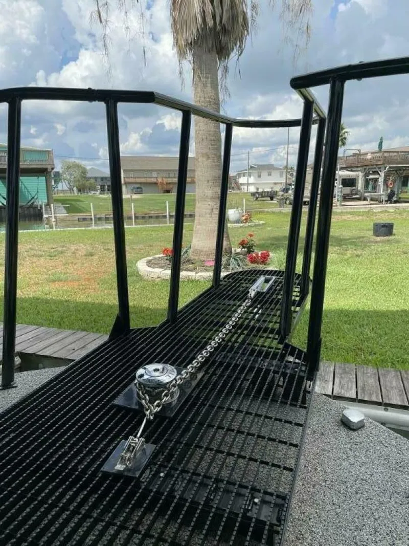 Slide: The Image of 1997 Custom 31 Center Console boat with black railing and anchor chain. - 22