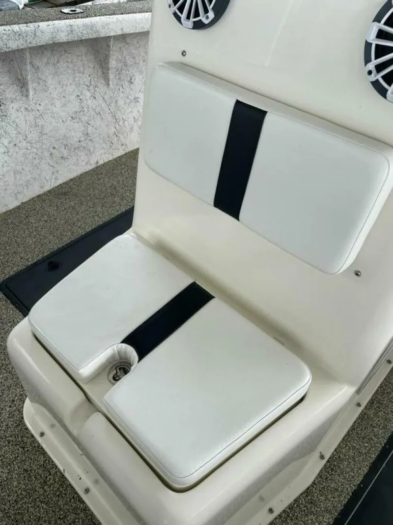 Slide: The Image of 1997 Custom 31 Center Console boat seat with white cushions and black stripe. - 27