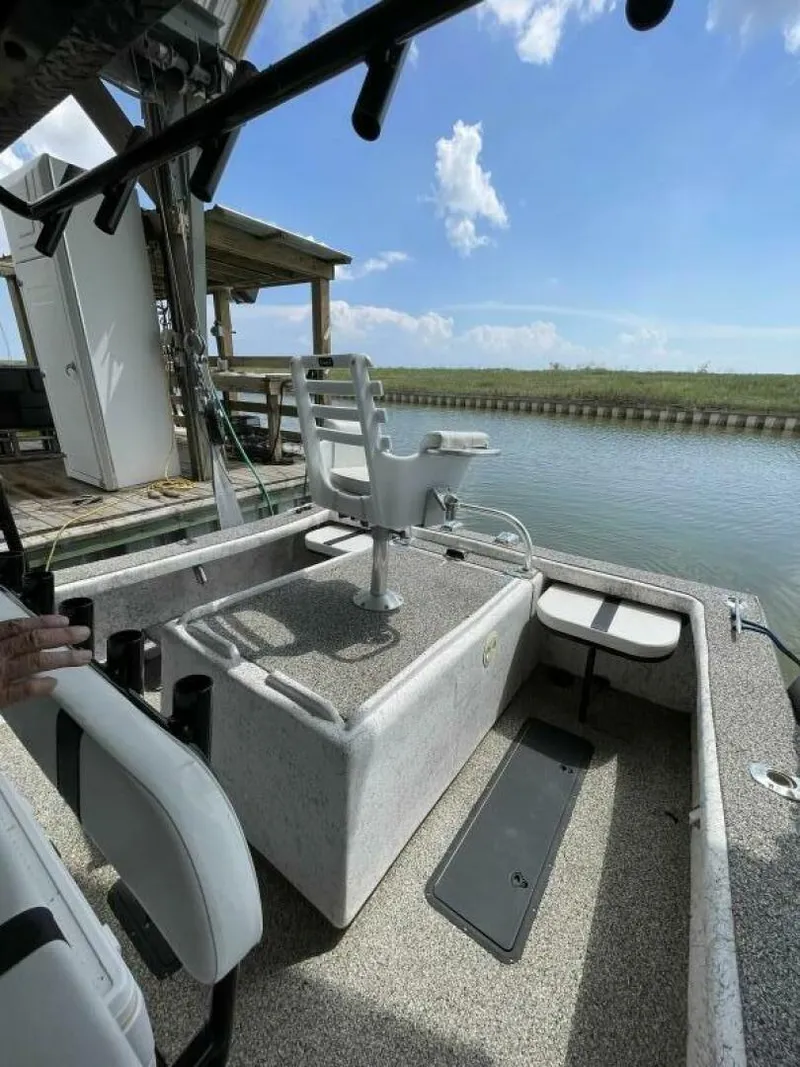 Slide: The Image of 1997 Custom 31 Center Console boat docked by a canal on a sunny day. - 29