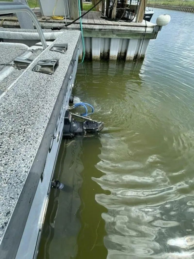 Slide: The Image of 1997 Custom 31 Center Console boat docked by the water. - 30