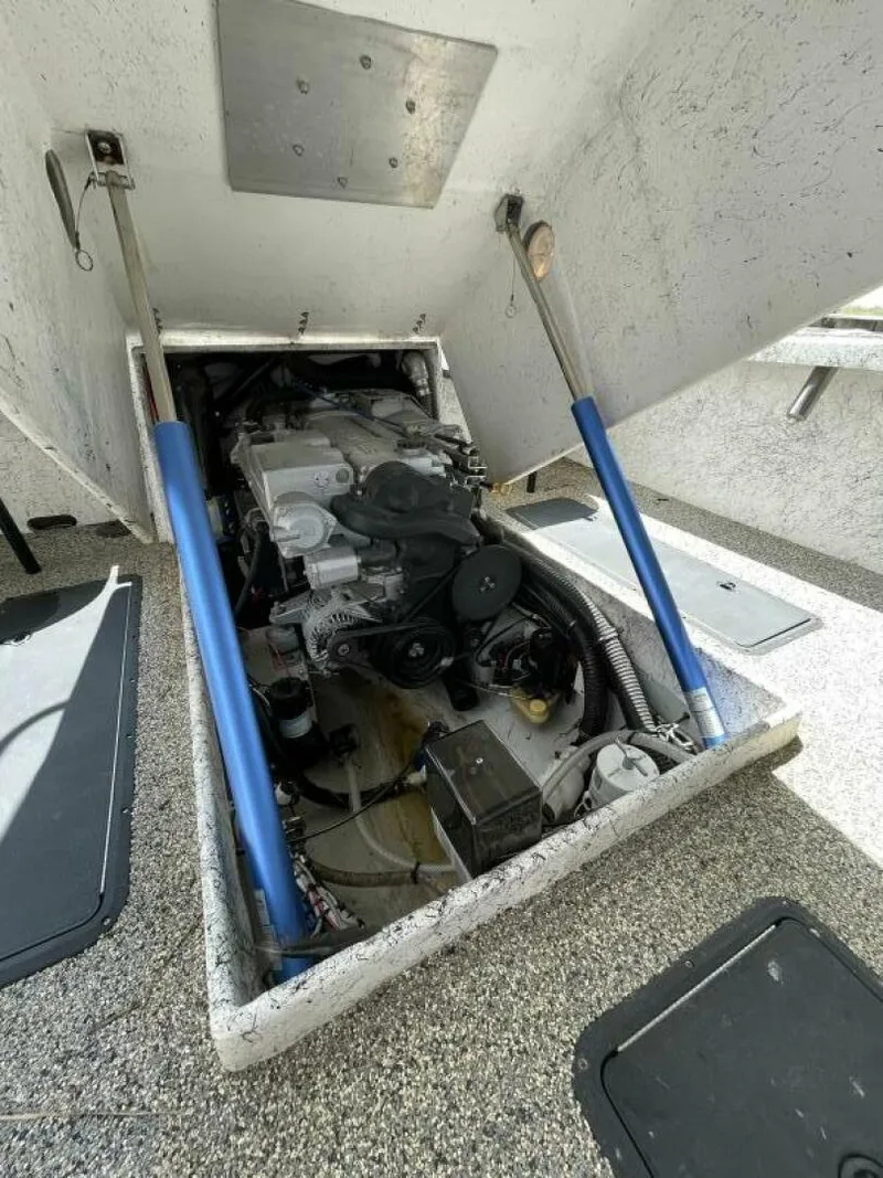 Slide: The Image of 1997 Custom 31 Center Console boat engine compartment with hydraulic lifts. - 37