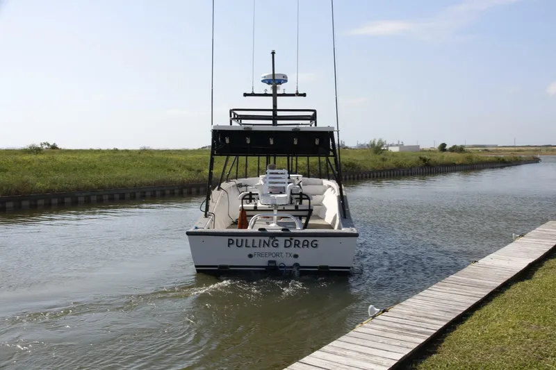 Slide: The Image of Custom 1997 31 Center Console boat named Pulling Drag in a narrow waterway. - 41