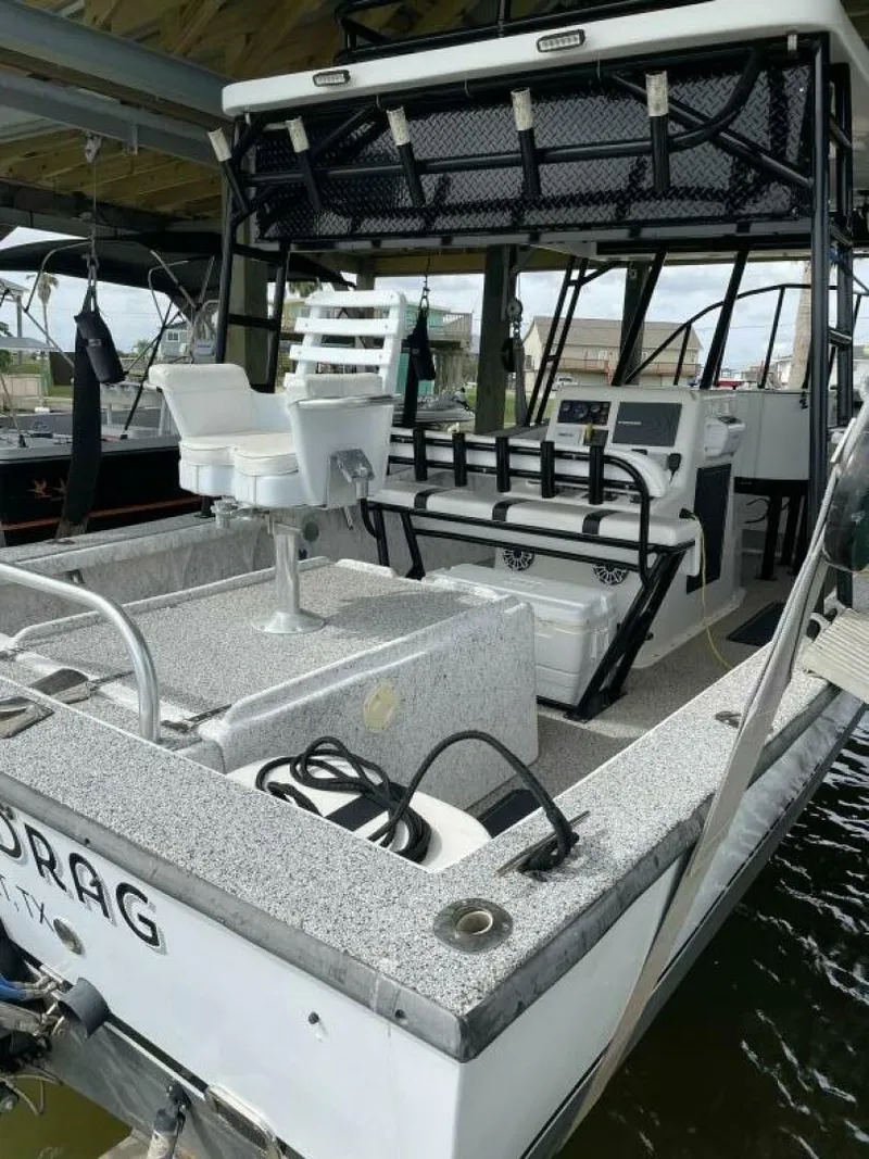 Slide: The Image of 1997 Custom 31 Center Console boat with fishing gear and seating. - 48