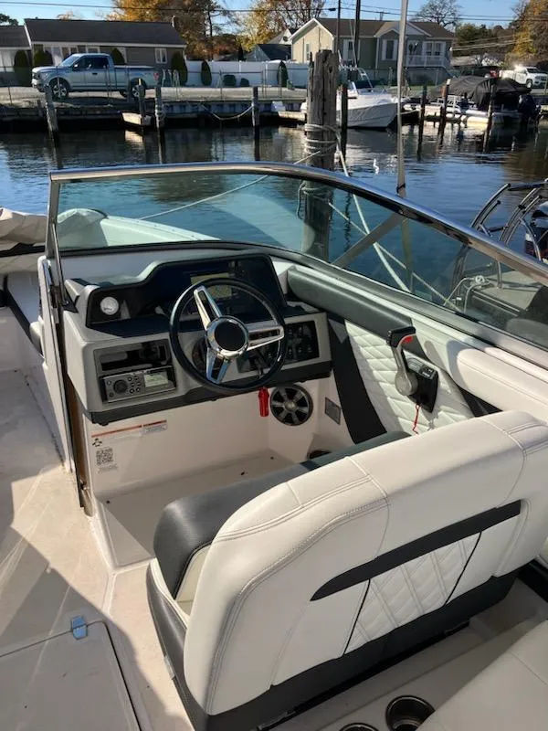 Slide: The Image of 2020 Regal 26 OBX boat interior with steering wheel and dashboard. - 11