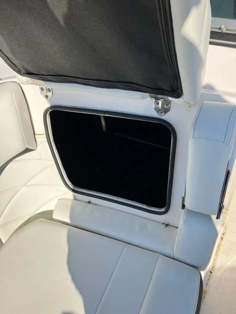 Slide: The Image of 2020 Regal 26 OBX boat storage compartment with open seat. - 13
