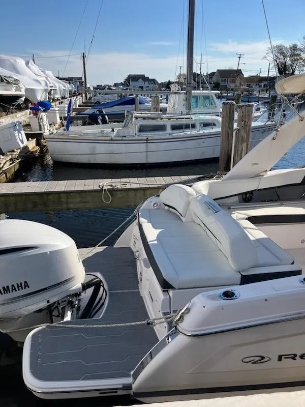 Slide: The Image of 2020 Regal 26 OBX boat docked with Yamaha outboard motor. - 2