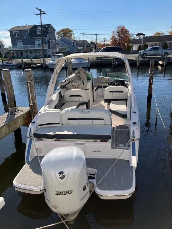 Slide: The Image of 2020 Regal 26 OBX boat docked in a marina. - 3