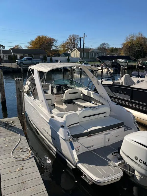 Slide: The Image of 2020 Regal 26 OBX boat docked at a marina. - 4