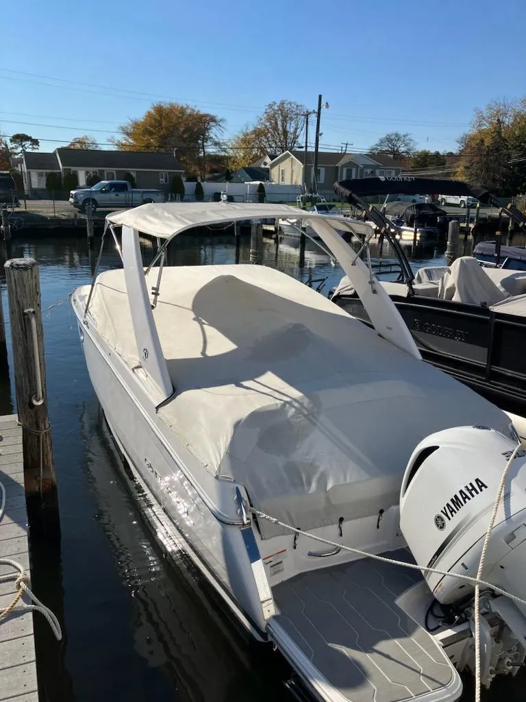 Slide: The Image of 2020 Regal 26 OBX boat docked with Yamaha outboard motor. - 6