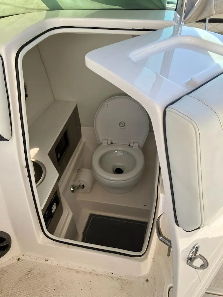 Slide: The Image of 2020 Regal 26 OBX boat interior bathroom with toilet. - 7