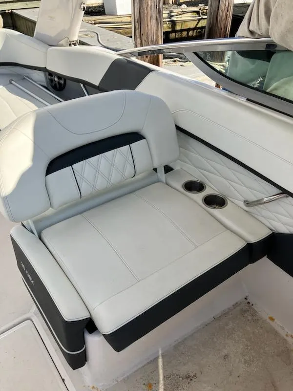 Slide: The Image of 2020 Regal 26 OBX boat interior with white leather seating and cup holders. - 8
