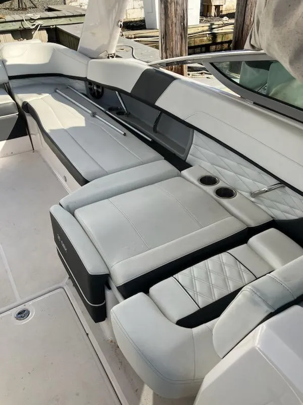 Slide: The Image of 2020 Regal 26 OBX boat interior with luxurious seating and cup holders. - 9