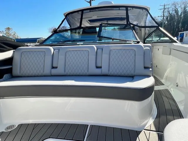 Slide: The Image of 2024 Sea Ray SLX 400 OB boat with luxurious seating and sleek design. - 13