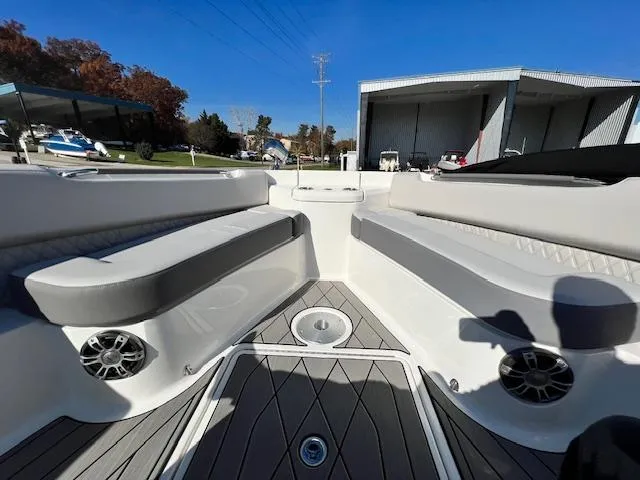 Slide: The Image of 2024 Sea Ray SLX 400 OB boat interior with cushioned seating and speakers. - 14