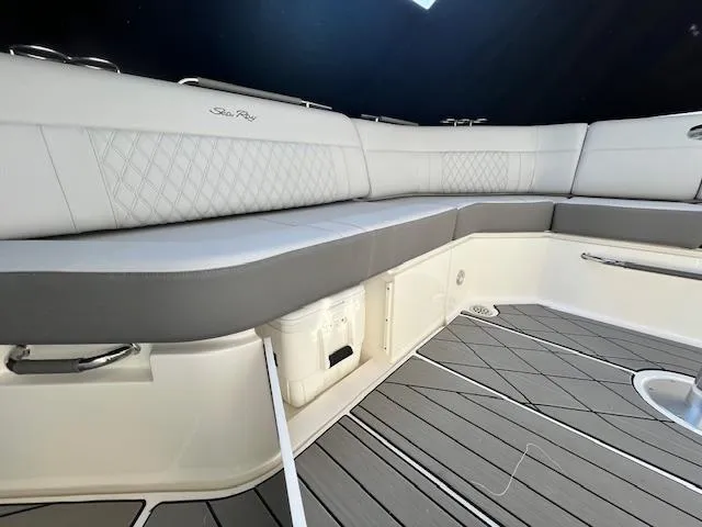 Slide: The Image of 2024 Sea Ray SLX 400 OB boat interior with cushioned seating and storage. - 19