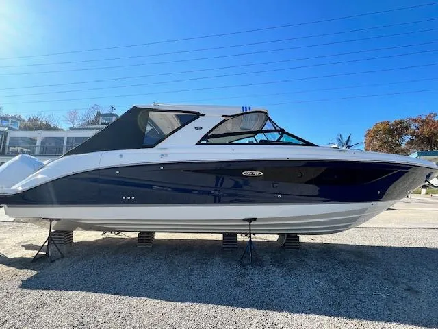 Slide: The Image of 2024 Sea Ray SLX 400 OB boat on display outdoors. - 2