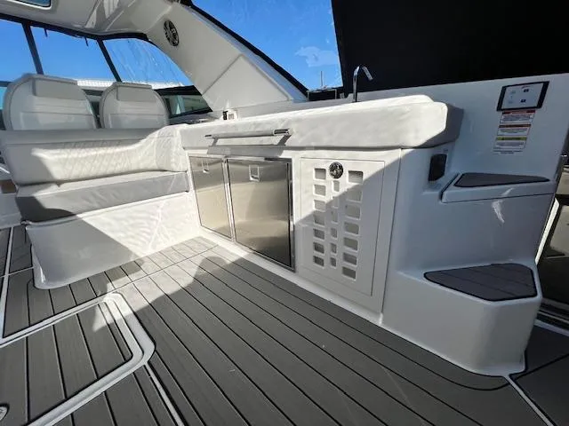 Slide: The Image of Interior of 2024 Sea Ray SLX 400 OB boat with seating and kitchenette. - 24