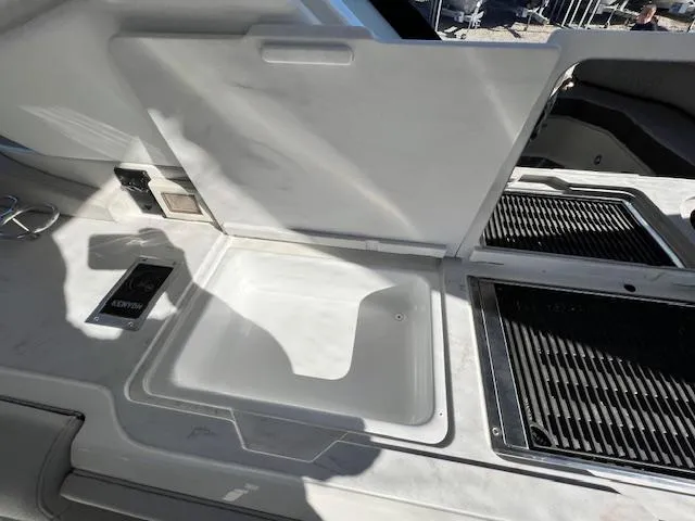 Slide: The Image of 2024 Sea Ray SLX 400 OB boat interior with open storage compartment. - 29