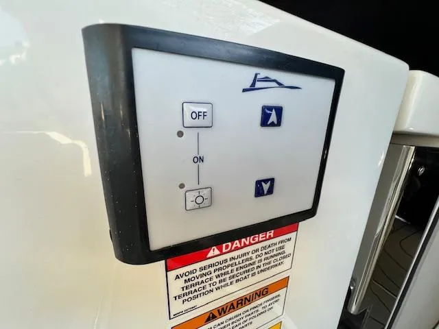 Slide: The Image of Control panel on a 2024 Sea Ray SLX 400 OB boat with warning labels. - 31