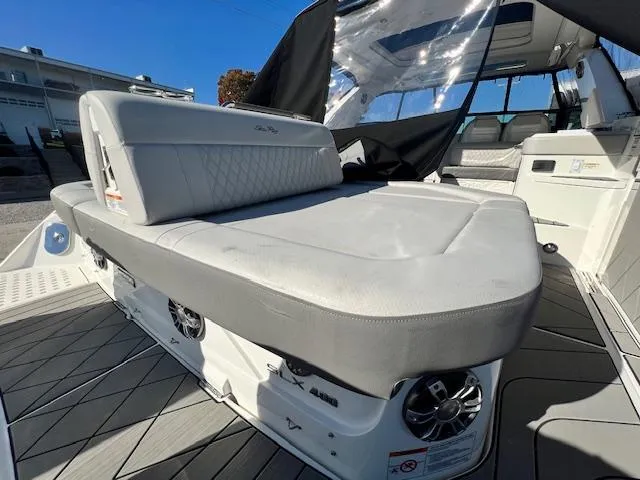 Slide: The Image of 2024 Sea Ray SLX 400 OB boat interior with cushioned seating and speakers. - 33