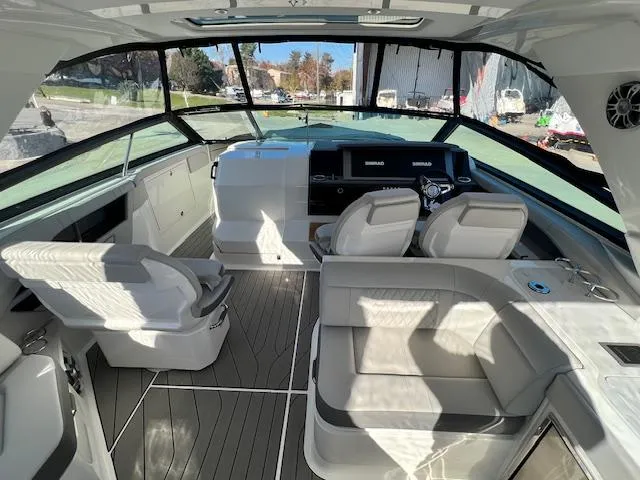 Slide: The Image of Interior of 2024 Sea Ray SLX 400 OB luxury boat with modern seating and dashboard. - 34