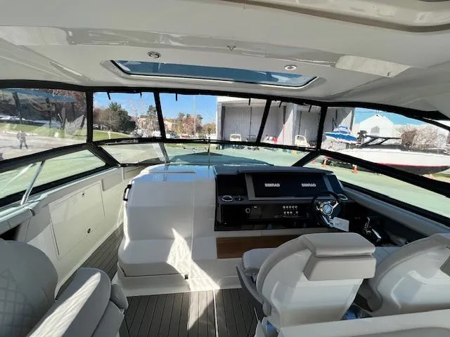 Slide: The Image of 2024 Sea Ray SLX 400 OB cockpit with modern helm and panoramic windows. - 42