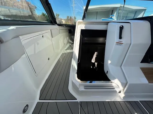 Slide: The Image of 2024 Sea Ray SLX 400 OB boat interior with open cabin door and sleek design. - 43