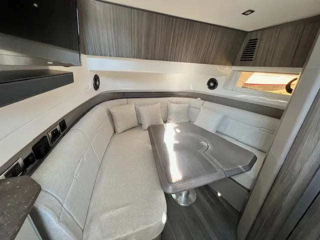 Slide: The Image of Interior of 2024 Sea Ray SLX 400 OB with modern seating and table. - 6