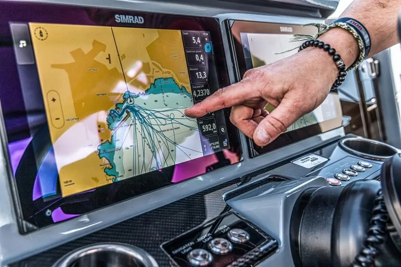 Slide: The Image of Person navigating BRABUS SHADOW 300 CT 2024 using Simrad touchscreen display. - 10
