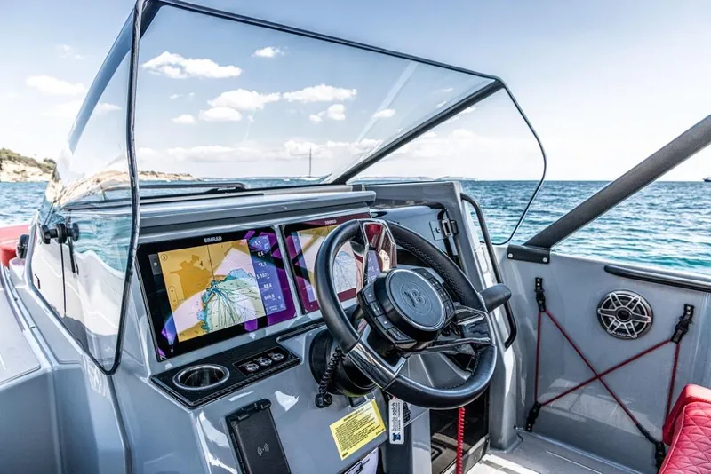 Slide: The Image of BRABUS SHADOW 300 CT 2024 boat dashboard with navigation screens and steering wheel. - 7