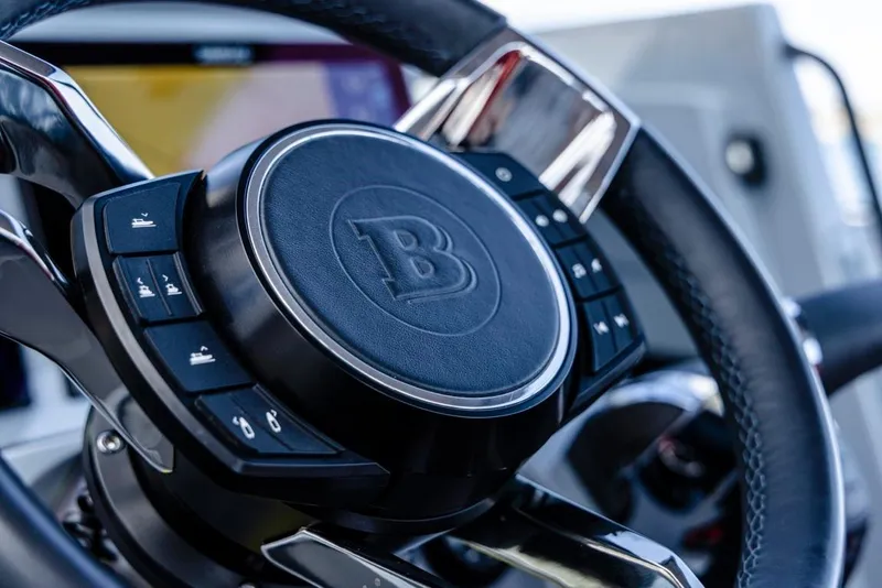 Slide: The Image of Close-up of 2024 BRABUS SHADOW 300 CT steering wheel with control buttons. - 9