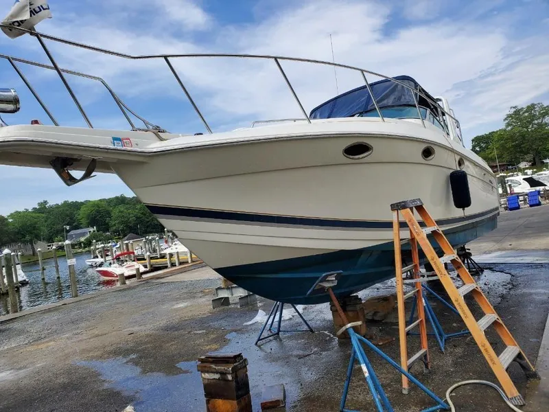 Slide: The Image of 2000 Formula 31 PC boat on dry dock with ladder and marina background. - 1