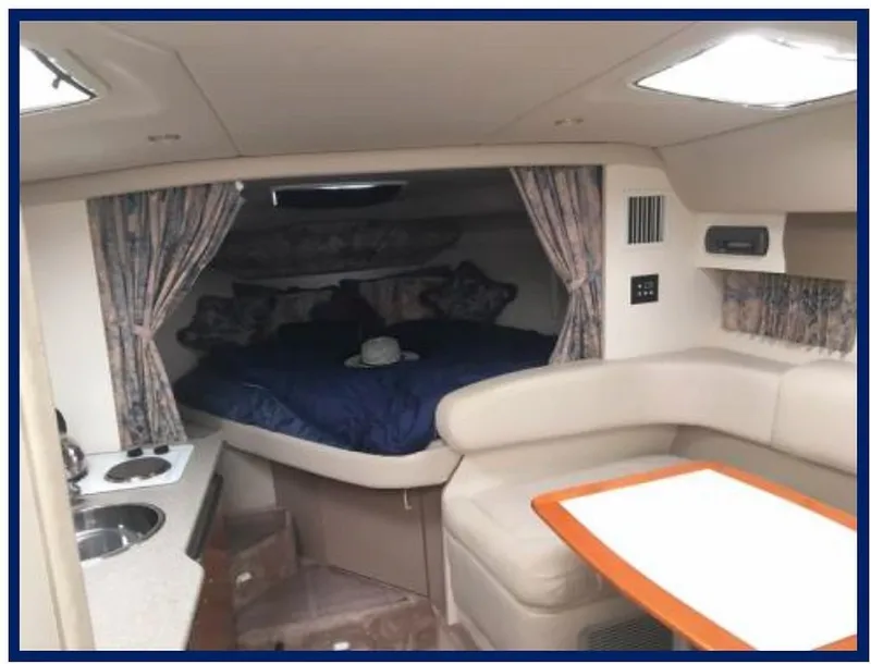 Slide: The Image of Interior of a 2000 Formula 31 PC boat with bed, kitchenette, and seating area. - 10