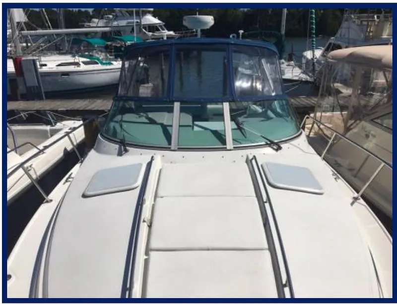 Slide: The Image of 2000 Formula 31 PC boat docked at a marina. - 12