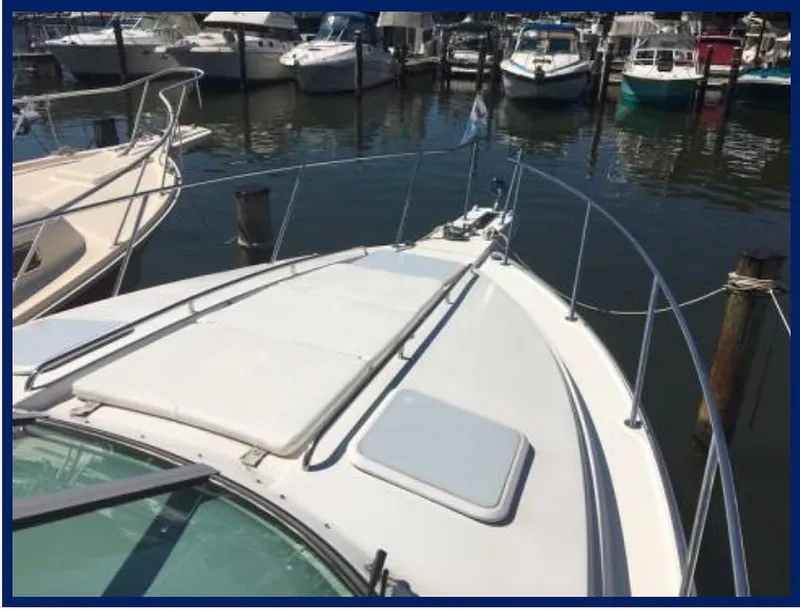 Slide: The Image of 2000 Formula 31 PC boat docked at a marina. - 14