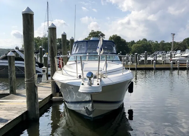 Slide: The Image of 2000 Formula 31 PC boat docked at a marina on a sunny day. - 2