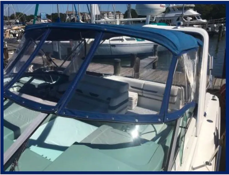 Slide: The Image of 2000 Formula 31 PC boat docked at a marina with blue canopy. - 6