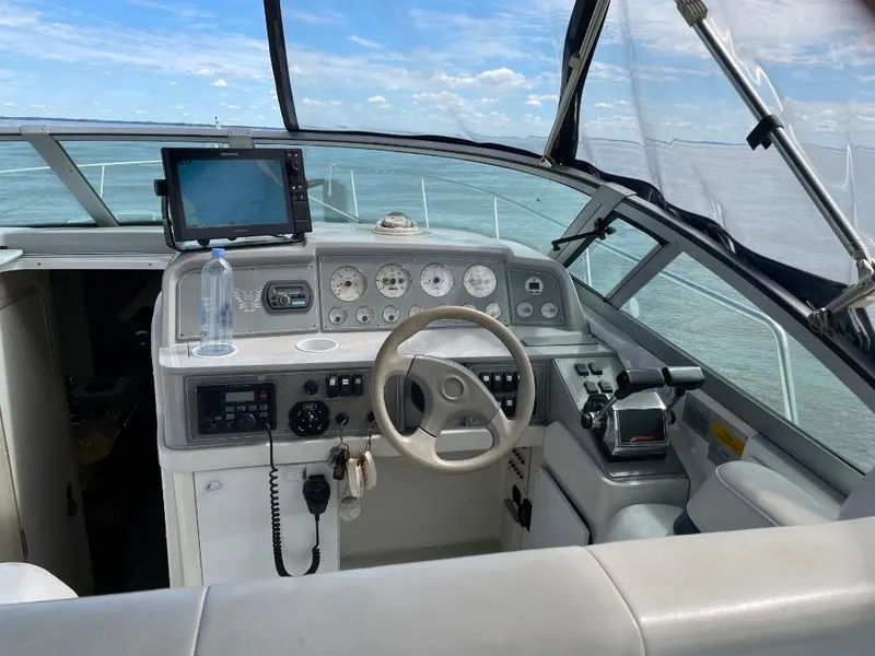 Slide: The Image of Cockpit of a 2000 Formula 31 PC boat with steering wheel and navigation equipment. - 7