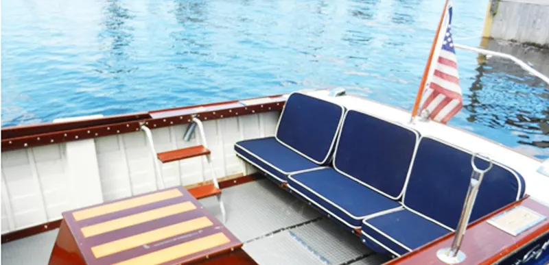 Slide: The Image of 1963 Chris-Craft Sportsman boat interior with blue seating and American flag. - 13