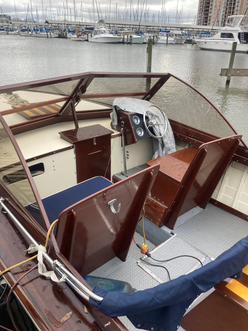 Slide: The Image of 1963 Chris-Craft Sportsman boat interior at a marina with other boats docked. - 14