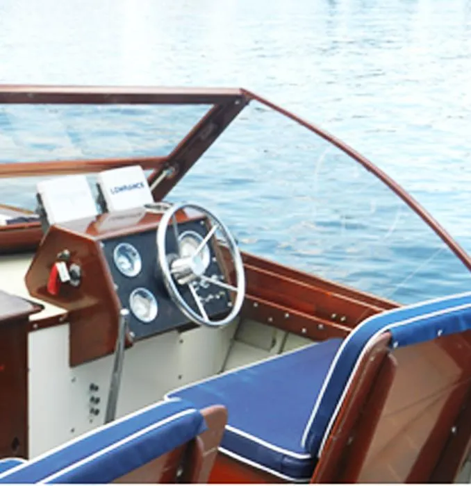 Slide: The Image of 1963 Chris-Craft Sportsman boat interior with steering wheel and blue seats. - 15