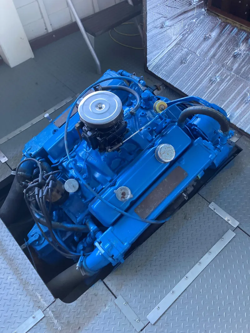 Slide: The Image of 1963 Chris-Craft Sportsman engine in blue, displayed on a metal platform. - 17