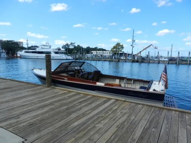 Slide: The Image of 1963 Chris-Craft Sportsman boat docked at a marina on a sunny day. - 2