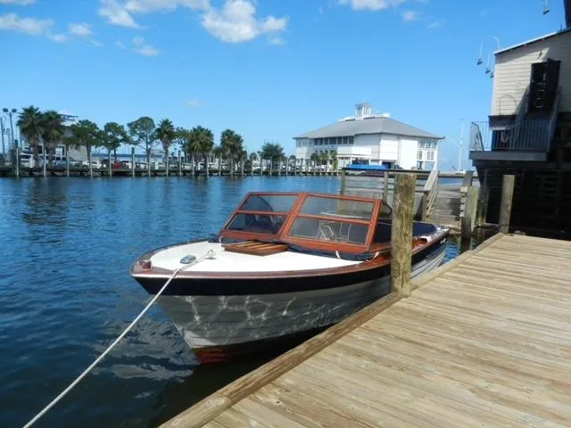 Slide: The Image of 1963 Chris-Craft Sportsman boat docked at a marina on a sunny day. - 3