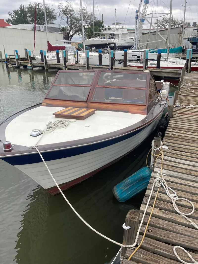 Slide: The Image of 1963 Chris-Craft Sportsman boat docked at a marina. - 8