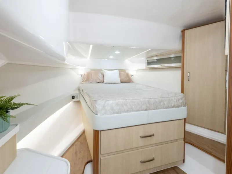 Slide: The Image of 2024 Regal 36 XO interior cabin with modern furnishings and wooden accents. - 17