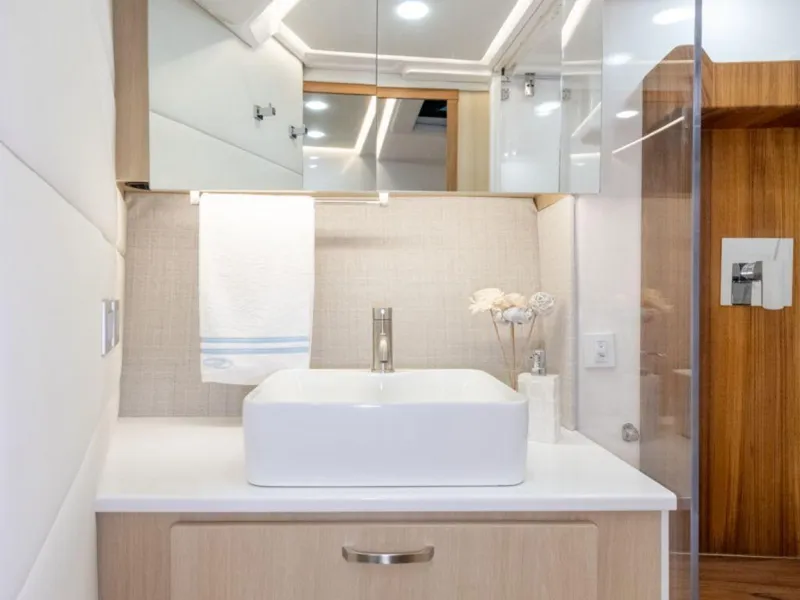 Slide: The Image of Modern bathroom vanity in 2024 Regal 36 XO yacht with sleek sink and mirror. - 20