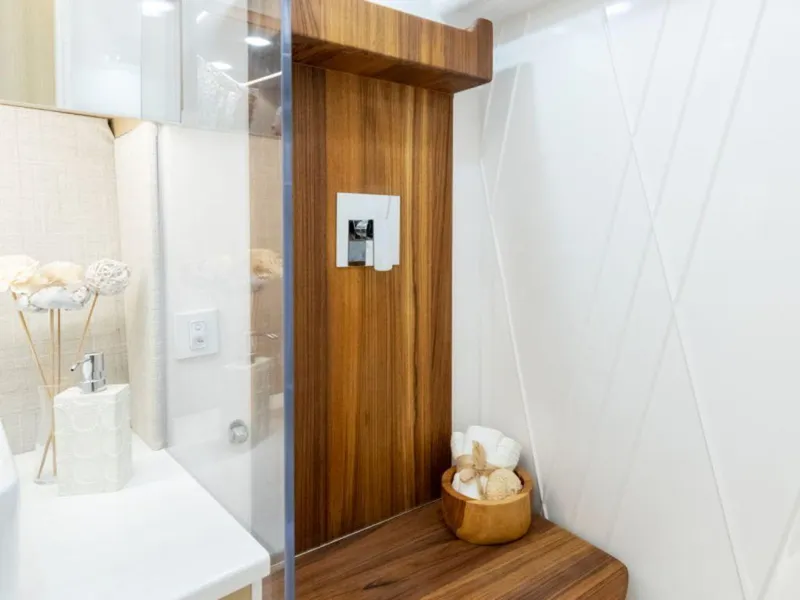 Slide: The Image of 2024 Regal 36 XO bathroom with modern wood accents and white fixtures. - 23